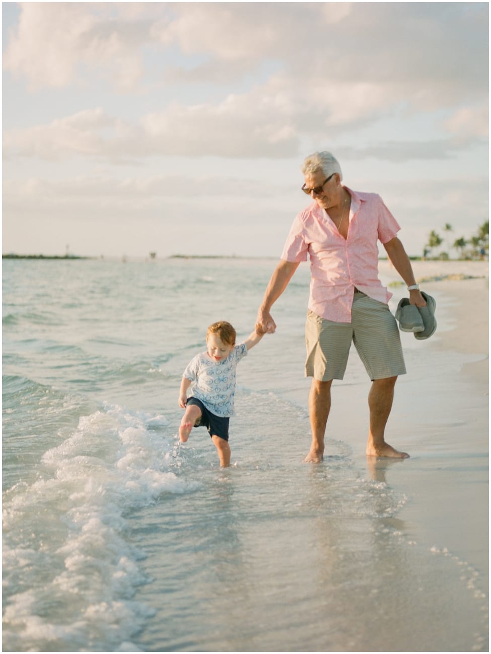 grandpa and grandson walking in naples florida for family shoot