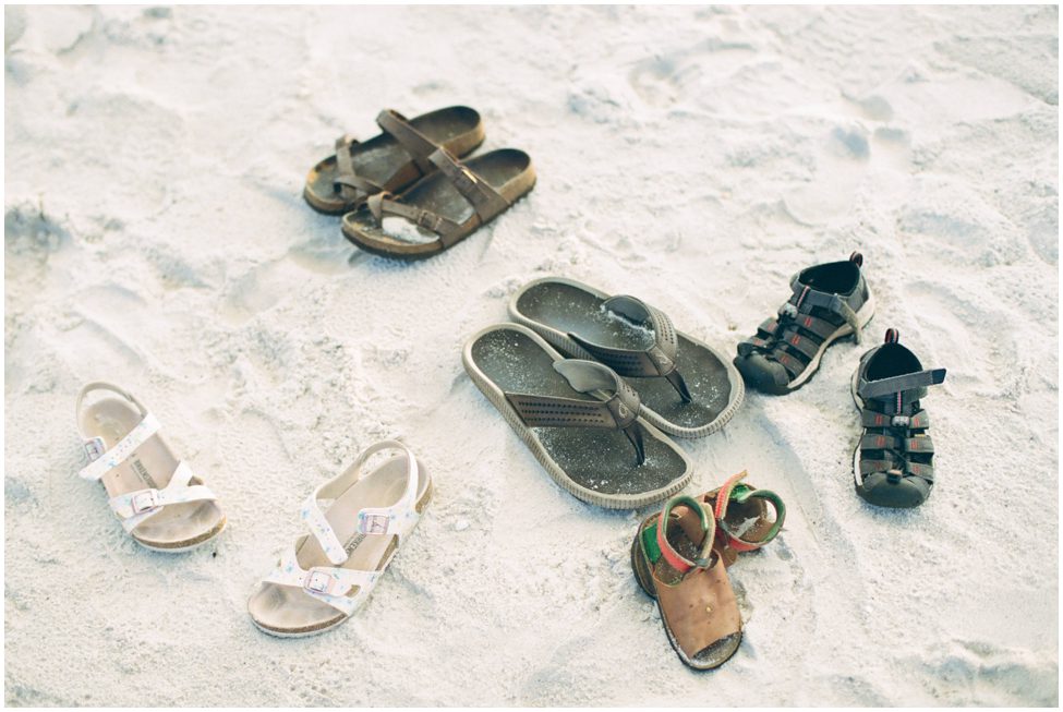 a set of shoes in the sand in Naples Florida from a family who is having their family vacation photos taken