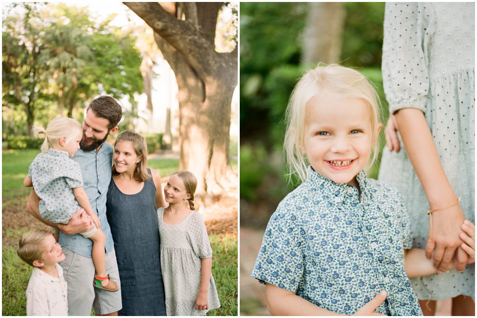 a family of five all smiling at each other with lush greenery in the background for family vacation photos in Naples, Florida. 