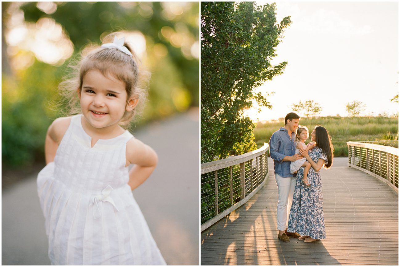 Family portraits at baker park with a little girl in a white dress and two parents with the sunsetting behind them