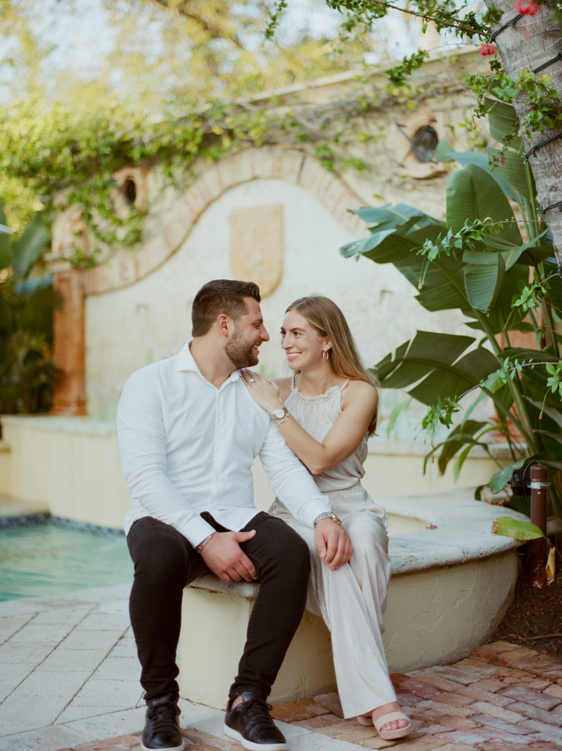 A couple sitting in the backyard of the hotel Escalante