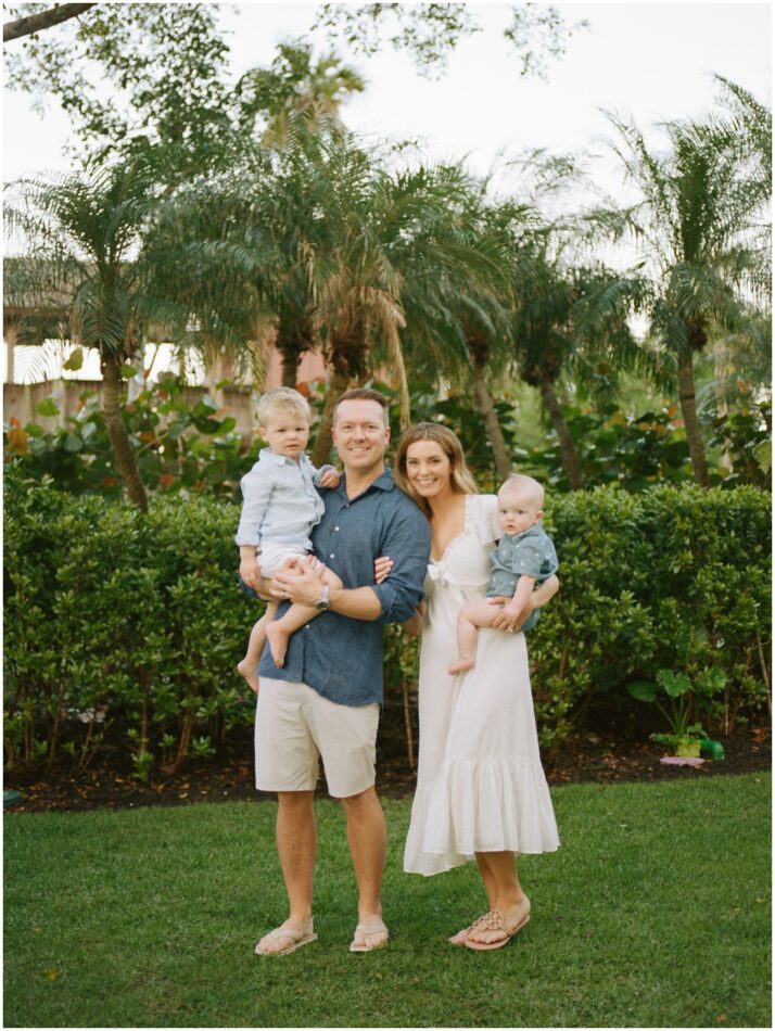 A family of four in the backyard of the Ritz Carlton in Naples for their family photos