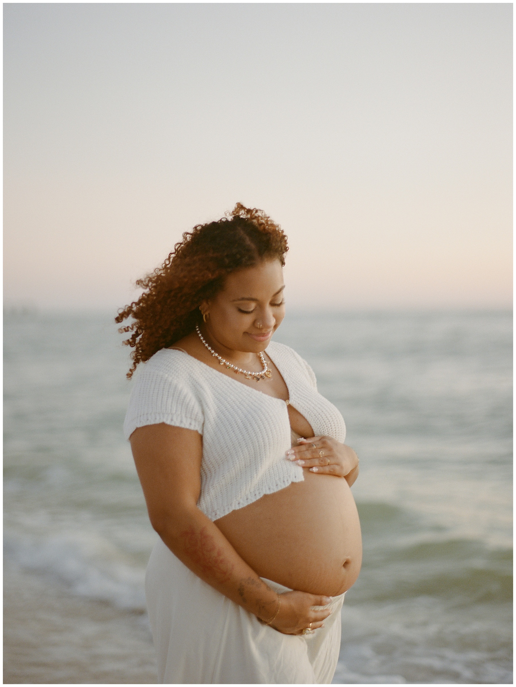 photo of a pregnant woman waist up on the beaches of Naples for her maternity photos