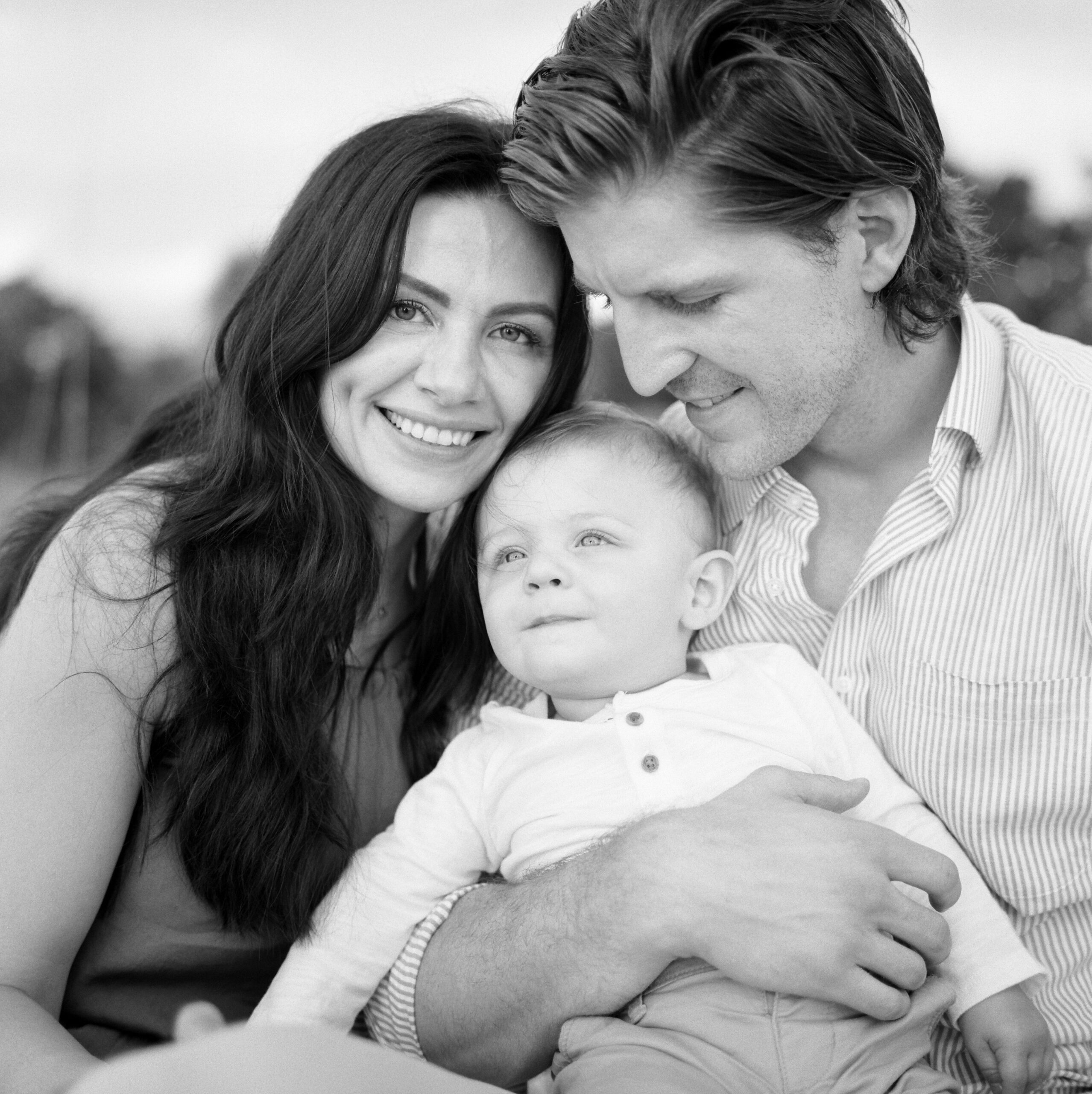 a family of three close up for a family photo in Naples Florida at the four seasons