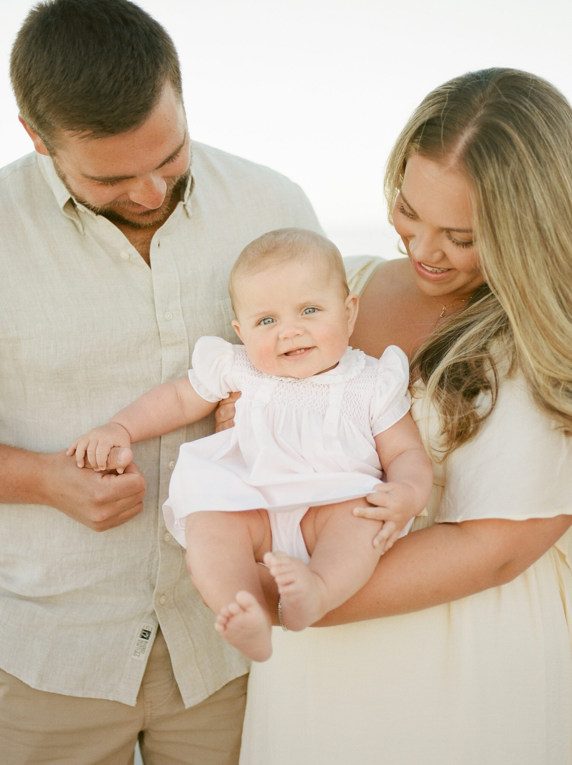 a family of three getting their photos taken at the Four Seasons in Naples