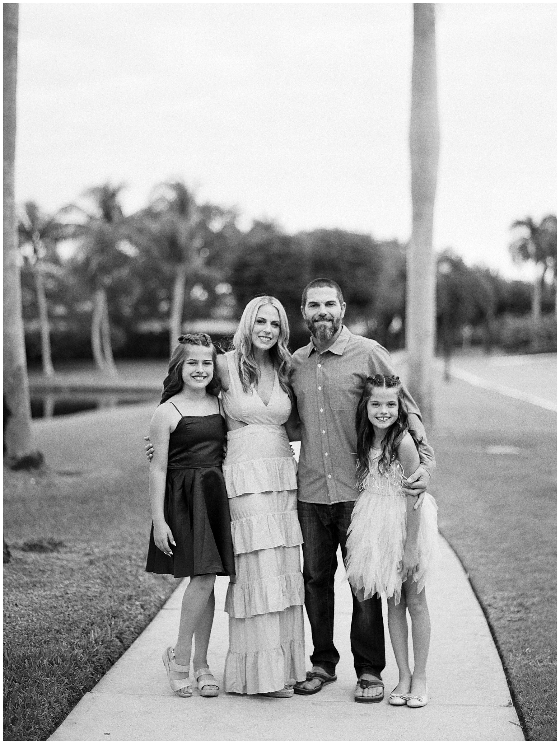 a holiday family portrait taken in black and white of a family of four